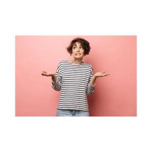 A female with short brown hair in a stripped black and white shirt. Standing in front of a pink background with her hands up looking confused. 